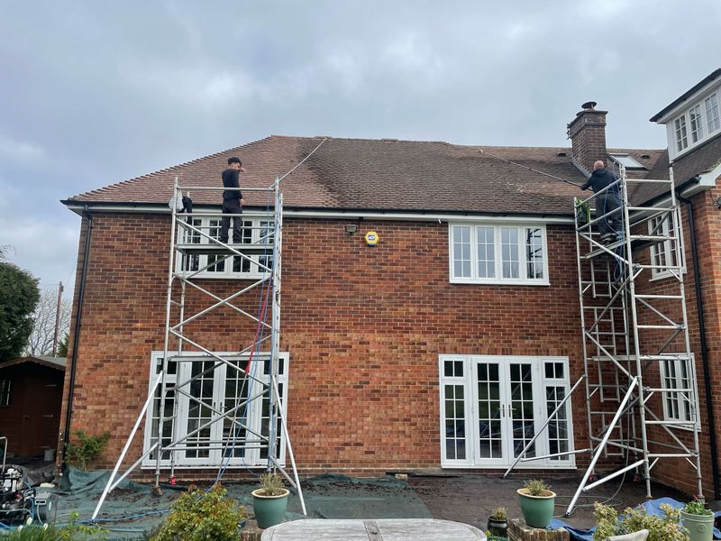 Roof cleaning carried out safely from scaffold towers by The Roof Moss Cleaners in Hook
